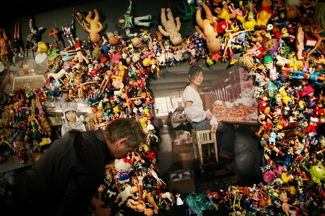 Finishing touches are made to The Real Toy Story by Michael Wolf (pictured), an installation of plastic toys, dolls and photography as part of the China Design Now exhibition in Liberty, London. (Photo by Graeme Robertson/The Guardian)