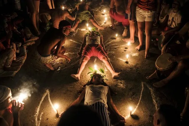 Followers of Maria Lionza's cult practice a ritual at Sorte Mountain in Venezuela's Yaracuy state, early Tuesday, October 12, 2021, one year after the annual pilgrimage was cancelled due to COVID-19 restrictions. Along with Santeria, Venezuela is home to other folk religions, such as the sect surrounding the Indian goddess Maria Lionza, an indigenous woman who according to tradition was born on Sorte Mountain and whose cult has spread to Colombia, Panama, Puerto Rico, Dominican Republic, and Central America. (Photo by Matias Delacroix/AP Photo)