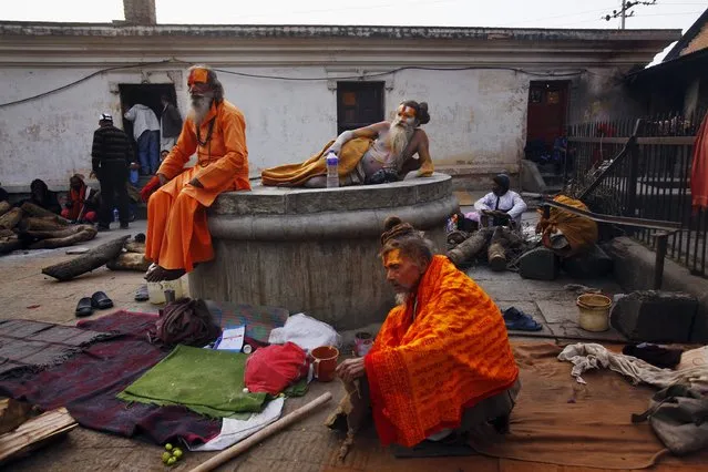 Hindu holy men rest in the courtyard of the Pashupatinath Temple in Katmandu, Nepal, Wednesday, February 26, 2014. (Photo by Niranjan Shrestha/AP Photo)