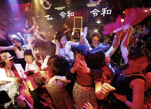 People celebrate the start of Japan's new Reiwa imperial era at the Maharaja nightclub in Tokyo's Roppongi district, May 1, 2019. Emperor Akihito announced his abdication at a palace ceremony Tuesday in his final address. (Photo by Kyodo News via Reuters)
