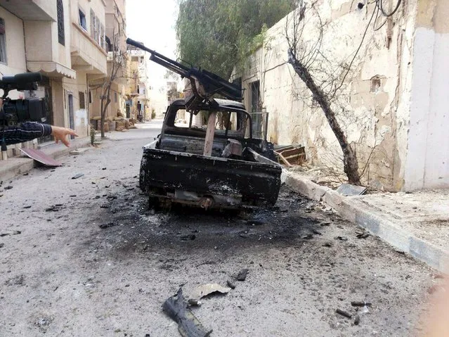 A burnt military vehicle is seen in Palmyra city after forces loyal to Syria's President Bashar al-Assad recaptured it, in Homs Governorate in this handout picture provided by SANA on March 27, 2016. (Photo by Reuters/SANA)