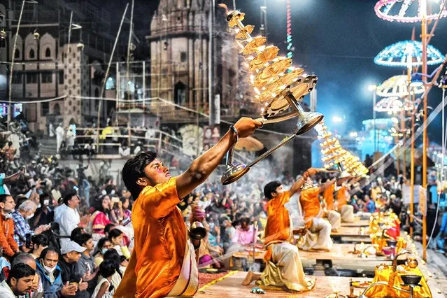 Hindu Priests performing Evening Aarati (Prayer) at Dashashwamedh Ghat on November 17, 2021, during the Ganga Aarti, a traditional and old Hindu ritual honouring the Ganges River which is held at the Banks of the river. (Photo by Avishek Das/SOPA Images/Rex Features/Shutterstock)