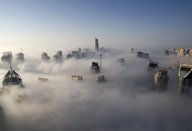 Heavy fog rolls by early in the morning near the Dubai Marina, United Arab Emirates, in this November 21, 2007 file photo. (Photo by Steve Crisp/Reuters)