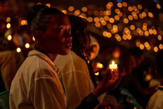 Participants hold a candle light night vigil during a commemoration event, known as “Kwibuka” (Remembering), as Rwanda marks the 30th anniversary of the 1994 Genocide, at the BK arena in Kigali, Rwanda on April 7, 2024. (Photo by Jean Bizimana/Reuters)
