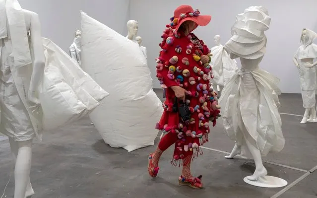 An arty dressed visitor looks at the artwork Life Dress (2018) by Barcelona-born and Amsterdam based artist Alicia Framis at the show Art Unlimited in the context of the international art show Art Basel, in Basel, Switzerland, 11 June 2019. Unlimited is Art Basel's exhibition platform for projects that transcend the limitations of a classical art-show stand, including out-sized sculpture and paintings, video projections, large-scale installations, and live performances. (Photo by Georgios Kefalas/EPA/EFE/Rex Features/Shutterstock)