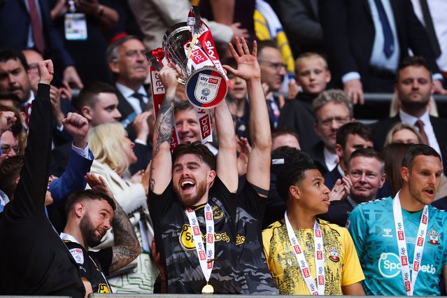 Southampton's Irish defender #03 Ryan Manning lifts the Championship play-off trophy after the English Championship play-off final football match between Leeds United and Southampton at Wembley Stadium in London on May 26, 2024. Southampton won the game 1-0. (Photo by Adrian Dennis/AFP Photo)
