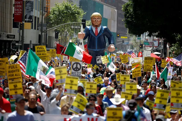 People march with an inflatable effigy of Republican presidential candidate Donald Trump during an immigrant rights May Day rally in Los Angeles, California, U.S., May 1, 2016. (Photo by Lucy Nicholson/Reuters)