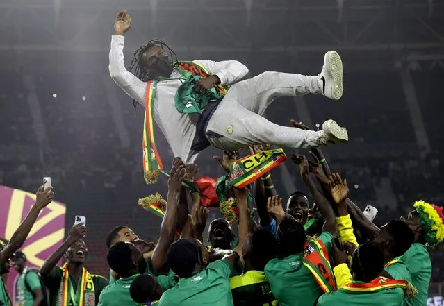Senegal's players celebrate with Senegal's head coach Aliou Cisse after winning the African Cup of Nations 2022 final soccer match between Senegal and Egypt at the Ahmadou Ahidjo stadium in Yaounde, Cameroon, Sunday, February 6, 2022. (Photo by Sunday Alamba/AP Photo)