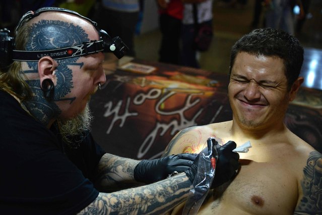 United Sates tattoer Paul Booth (L) participates in the 5th Edition of the Paradise Tatto International Convention, in San Antonio de Belen, 20 km west of the San Jose, on May 8 2016 with the participation of more than 300 local and international artists tattooers. (Photo by Ezequiel Becerra/AFP Photo)