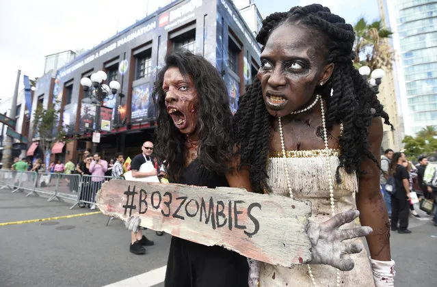 Two zombies wander through the Gaslamp District on first day of the 2015 Comic-Con International held at the San Diego Convention Center Thursday, July 9, 2015 in San Diego. (Photo by Denis Poroy/Invision/AP Photo)