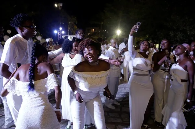 Attendees dance during 2019 Haiti Diner en Blanc event in Cap Haitien, Haiti, August 10, 2019. (Photo by Andres Martinez Casares/Reuters)