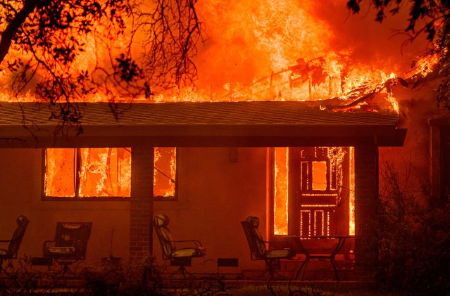 Flames engulf a home during the Thompson fire in Oroville, California on July 2, 2024. A heatwave is sending temperatures soaring resulting in red flag fire warnings throughout the state. (Photo by Josh Edelson/AFP Photo)