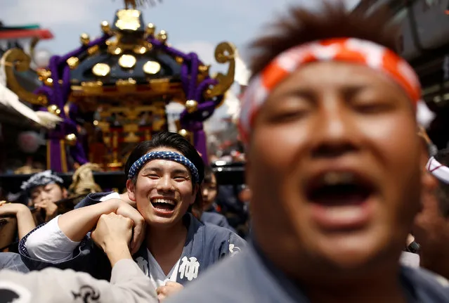 People carry a portable shrine, a Mikoshi, near the Senso-ji Temple during the Sanja festival in Tokyo's Asakusa district, Japan, May 15, 2016. (Photo by Thomas Peter/Reuters)