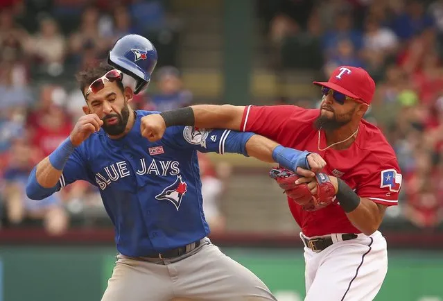 Toronto Blue Jays Jose Bautista (19) gets hit by Texas Rangers second baseman Rougned Odor (12) after Bautista slid into second in the eighth inning of a baseball game at Globe Life Park in Arlington, Texas, Sunday May 15, 2016. (Photo by Richard W. Rodriguez/Star-Telegram via AP Photo)