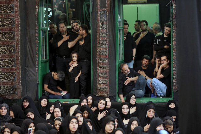 People attend a mourning ritual to commemorate Prophet Mohammed's grandson Imam Hussein and his 72 loyal companions, who died at the battle of Karbala, during the month of Muharram on the Islamic calendar in Tehran, Iran on July 15, 2024. (Photo by Fatemeh Bahrami/Anadolu via Getty Images)