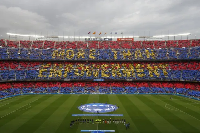 Supporters hold up banners reading “More than empowerment” before the Women's Champions League quarter final, second leg soccer match between Barcelona and Real Madrid at Camp Nou stadium in Barcelona, Spain, Wednesday, March 30, 2022. (Photo by Joan Monfort/AP Photo)