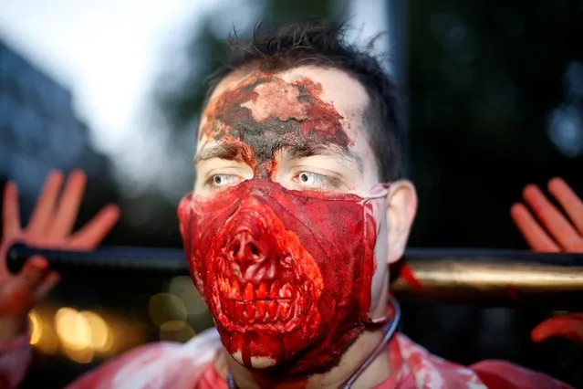 A person dressed up as a zombie attends a “Zombie walk” on Halloween in Essen, Germany, October 31, 2019. (Photo by Leon Kuegeler/Reuters)