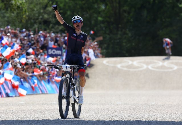 Britain's Thomas Pidcock celebrates his victory after winning the men's cross-country mountain biking event during the Paris 2024 Olympic Games in Elancourt Hill venue in Elancourt, on July 29, 2024. (Photo by Matthew Childs/Reuters)