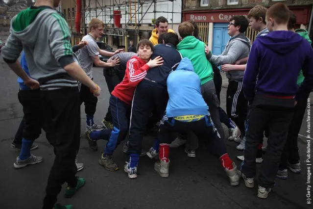 Youths tussle for the leather ball during the annual 'Fastern Eve Handba' event in Jedburgh's High Street in the Scottish Borders in Jedburgh
