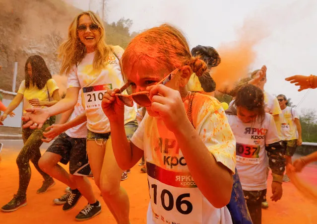 A girl reacts as she is sprayed with coloured powder during the YARKOcross colour run race in Almaty, Kazakhstan, June 5, 2016. (Photo by Shamil Zhumatov/Reuters)