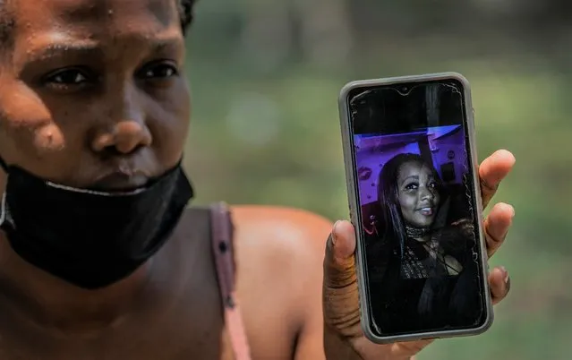 Beatriz Cespedes shows a photo on her phone of her 27-year-old sister Shaidis Cobas who works as a waitress at the Hotel Saratoga and who is still unaccounted for, while she waits for news about her near the site of a deadly explosion that destroyed the five-star hotel in Old Havana, Cuba, Monday, May 9, 2022. (Photo by Ramon Espinosa/AP Photo)