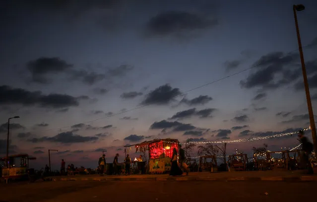 A Palestinian man sells corn and coffee on the beach at sunset, in west Gaza City, 17 October 2019. (Photo by Mohammed Saber/EPA/EFE)