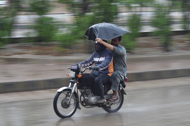 Two people make their way on a motorbike during heavy downpour in Karachi, Pakistan, 28 August 2024. The Met Department of Pakistan has forecasted widespread rainfall and potential flooding across multiple regions, with heavy downpours expected in Bannu, Lakki Marwat, Dera Ismail Khan, and several cities in Sindh and Punjab, including Bahawalpur and Karachi. The Provincial Disaster Management Authority (PDMA) has issued an alert for Punjab, warning of urban and flash flooding, and advising deputy commissioners to stay prepared for emergencies. The monsoon spell is anticipated to last until August 31, with recent reports indicating normal water flow in rivers, though concerns about flood risks in Dera Ghazi Khan and Rajanpur persist. (Photo by Shahzaib Akber/EPA/EFE)