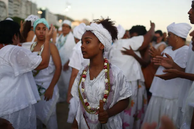 Believers of Afro-Brazilian religions pay tribute to Yemanja during a traditional celebration ahead of New Year's eve on Copacabana beach in Rio de Janeiro, Brazil on December 28, 2019. (Photo by Pilar Olivares/Reuters)