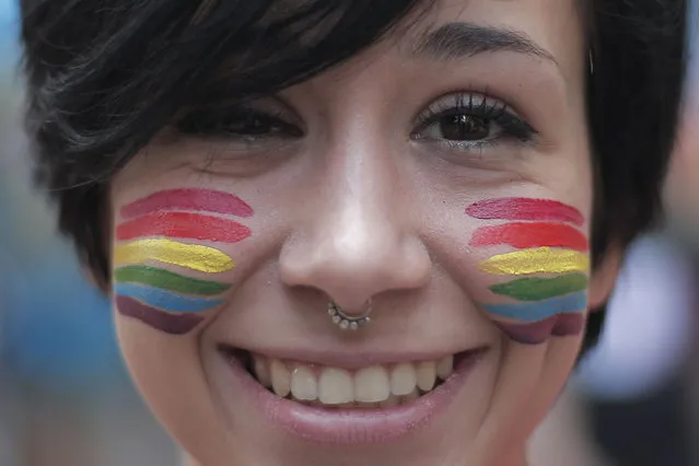 A girl with a “rainbow” makeup takes part in the annual Lesbian, Gay, Bisexual and Transgender (LGBT) Pride Parade in Turin, on June 28, 2014. (Photo by Marco Bertorello/AFP Photo)