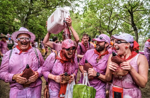 People attend the traditional “Battle of Wine” in the town of Haro, La Rioja province, northern Spain, 29 June 2024. More than eight thousand people took part in the Battle of Wine, celebrated annually on 29 June, where more than 40,000 liters of wine have been poured among participants equipped with all kinds of “weapons”, from water pistols to sprayers. (Photo by Fernando Diaz/EPA)