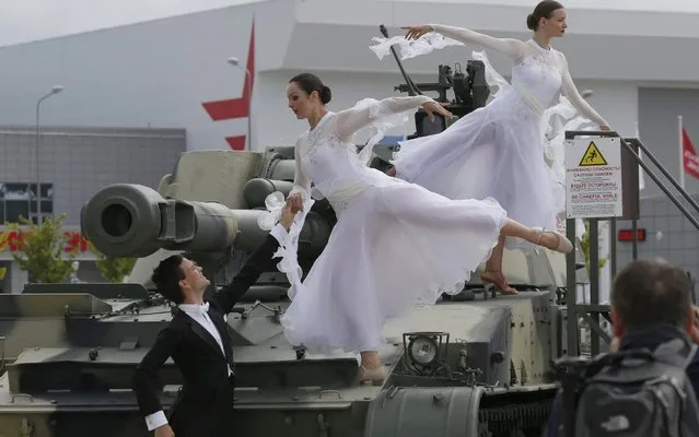 Dancers on a 2S3M Akatsiya 152mm self-propelled howitzer at the opening of the 2019 International Army Games at the Patriot Congress and Exhibition Centre in Kubinka outside Moscow, Russia on August 3, 2019. (Photo by Sergei Karpukhin/TASS)