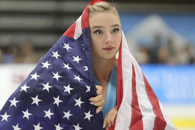 Flag-draped Amber Glenn, of the United States, skates around the rink after her third-place finish at the U.S. International Figure Skating Classic on Saturday, September 21, 2019, in Salt Lake City. (Photo by Rick Bowmer/AP Photo)