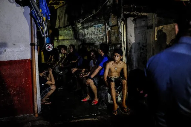 Suspected drug users and drug dealers are arrested by police during a nighttime raid on a suspected drug den, June 16, 2016, in Manila, Philippines. (Photo by Dondi Tawatao/Getty Images)