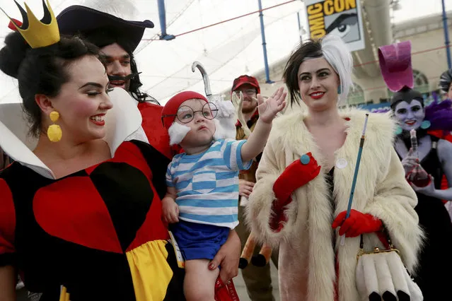 Costumed attendees pose during the 2014 Comic-Con International Convention in San Diego, California July 24, 2014. (Photo by Sandy Huffaker/Reuters)