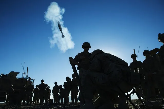 A mortar flies out of a tube during a mortar exercise for U.S. soldiers in Dragon Company of the 3rd Cavalry Regiment near forward operating base Gamberi in the Laghman province of Afghanistan December 26, 2014. (Photo by Lucas Jackson/Reuters)