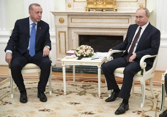 Russian President Vladimir Putin, right, and Turkish President Recep Tayyip Erdogan talk during their meeting in the Kremlin, in Moscow, Russia, Thursday, March 5, 2020. The Turkish and Russian leaders are holding talks in Moscow aimed at avoiding pitting their nations against each other, during hostilities in northwestern Syria. (Photo by Pavel Golovkin/AP Photo/Pool)