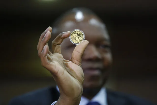 Reserve Bank of Zimbabwe governor John Mangudya shows the new gold coin to the media at his offices in Harare, Zimbabwe, 25 July 2022. In a dare move to tackle the soaring inflation, the one-ounce, 22-carat gold coins, the Mosi -oa-Tunya gold coins (named after Victoria Falls), will be sold in local currency and other foreign currencies. (Photo by Aaron Ufumeli/EPA/EFE/Rex Features/Shutterstock)