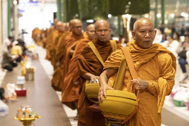 Buddhist monks arrive for a ceremony to reopen the Terminal 21 shopping mall in Nakhon Ratchasima, Thailand, Thursday, February 13, 2020. The worst-ever mass shooting in the country took place at the shopping mall over the weekend. (Photo by Sakchai Lalit/AP Photo)
