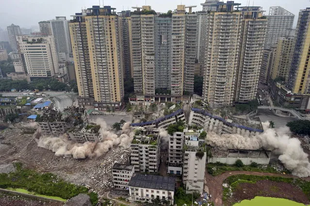 Old residential buildings are demolished with controlled blasting in Chongqing municipality, China, June 16, 2015. (Photo by Reuters/China Daily)