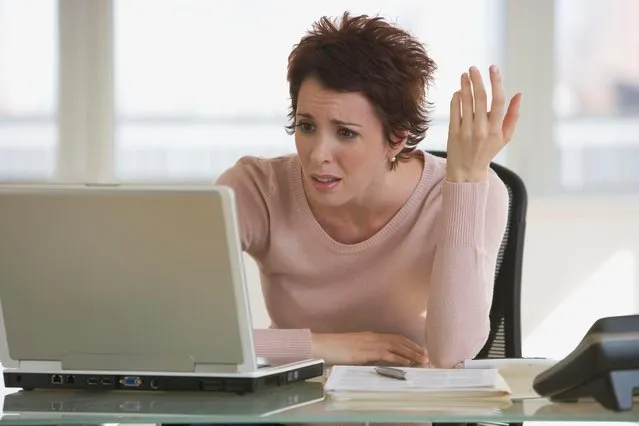 Frustrated businesswoman looking at laptop. (Photo by Tetra Images/Alamy Stock Photo)