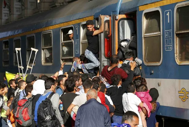 Migrants stoming trains in the Keleti train station in Budapest, Hungary, September 3, 2015 as Hungarian police withdrew from the gates after two days of blocking their entry. (Photo by Laszlo Balogh/Reuters)