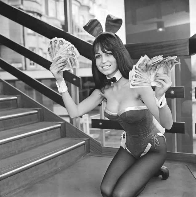 Playboy Club Bunny Girl Christel posing with money after the Playboy Club announces a pay increase for women working at the club in the hope to attract employees, London, 16th March 1972. (Photo by Ronald Dumont/Daily Express/Hulton Archive/Getty Images)