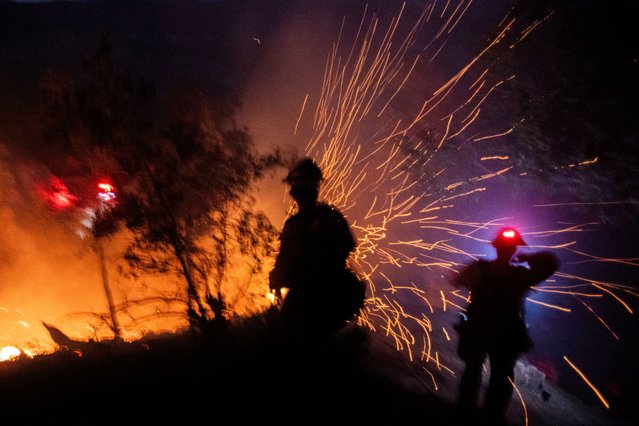 The wind whips embers while firefighters battle the fire in the Angeles National Forest near Mt. Wilson as the wildfires burn in the Los Angeles area, during the Eaton Fire in Altadena, California, U.S. January 9, 2025. (Photo by Ringo Chiu/Reuters)