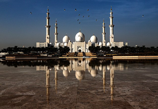 Birds fly over the Sheikh Zayed Mosque where the “Light and Peace” Museum is taking place in Abu Dhabi, United Arab Emirates, 17 December 2024. The “Light and Peace” Museum at the Sheikh Zayed Grand Mosque Centre showcases scientific, literary, and historical works reflecting Islamic civilization's depth and interactions with world cultures. (Photo by Ali Haider/EPA)