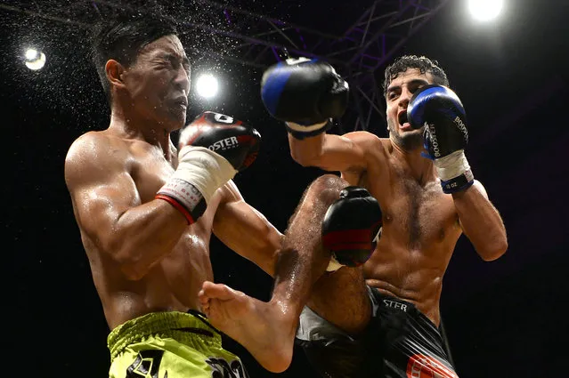 Moroccan fighter Youssef Haji (R) competes against Lu Jiambo of China in a kickboxing fight at the Grand Prix Majesty Mohammed VI Championship Fight Night event in the coastal Moroccan city of Tangiers on August 4, 2016. (Photo by Fadel Senna/AFP Photo)