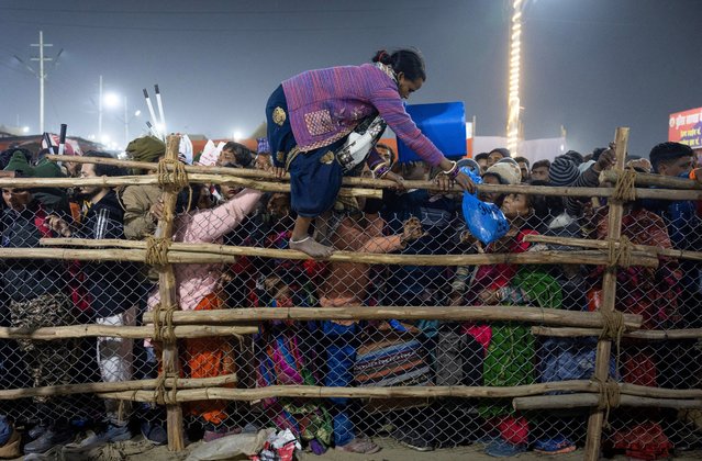 A devotee crosses over a barricade, after a deadly stampede before the second “Shahi Snan” (royal bath), at the “Maha Kumbh Mela” or the Great Pitcher Festival in Prayagraj, India on January 29, 2025. (Photo by Adnan Abidi/Reuters)