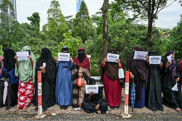 Somali's women refugees hold placards as they gather to protest against their living conditions in Malaysia, outside the office of the United Nations High Commissioner For Refugees (UNHCR) in Kuala Lumpur on November 20, 2024. (Photo by Mohd Rasfan/AFP Photo)