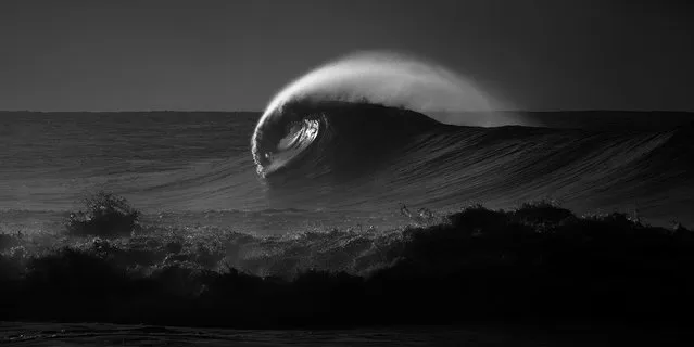 “Solitude”. A lone wave breaks along the Na Pali Coast on the north shore of Kaua'i. Photo location: Ke'e Beach, Kaua'i, Hawai'i. (Photo and caption by Aaron Feinberg/National Geographic Photo Contest)