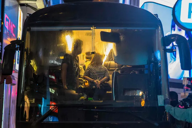 Police detain people on a bus after they cleared protesters taking part in a rally against a new national security law in Hong Kong on July 1, 2020, on the 23rd anniversary of the city's handover from Britain to China. (Photo by Dale de la Rey/AFP Photo)