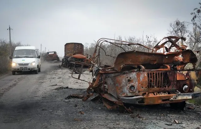 Burnt military cars are seen on the road after heavy battles between Ukrainian troops and Russian invaders in Mykolaiv region, Ukraine, Saturday, November 12, 2022. (Photo by Efrem Lukatsky/AP Photo)